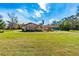 Backyard view of a ranch home with a large sunroom at 4045 Jason St, New Smyrna Beach, FL 32168