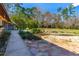 Stone patio walkway leads to a tranquil pond feature at 4045 Jason St, New Smyrna Beach, FL 32168