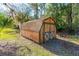 Small barn-style shed nestled in a wooded area at 4045 Jason St, New Smyrna Beach, FL 32168