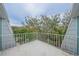 Private balcony with metal railing overlooking treetops at 4150 S Atlantic Ave # 112C, New Smyrna Beach, FL 32169