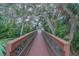 Wooden boardwalk path through lush tropical foliage at 4150 S Atlantic Ave # 112C, New Smyrna Beach, FL 32169