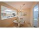 Bright dining area with glass table and four chairs, adjacent to kitchen at 4150 S Atlantic Ave # 112C, New Smyrna Beach, FL 32169