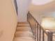 Carpeted staircase with dark wood railing at 4150 S Atlantic Ave # 112C, New Smyrna Beach, FL 32169