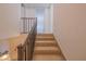 Carpeted staircase with simple dark wood railing at 4150 S Atlantic Ave # 112C, New Smyrna Beach, FL 32169