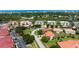 Aerial view of a meticulously maintained condo community surrounded by lush greenery and waterways at 432 Bouchelle Dr # 403, New Smyrna Beach, FL 32169