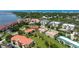 Scenic aerial shot of condo community boasting red tile roofs, landscaping, and waterfront access at 432 Bouchelle Dr # 403, New Smyrna Beach, FL 32169