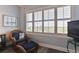 Brightly lit bedroom with sitting area, coastal decor, and plantation shutters at 432 Bouchelle Dr # 403, New Smyrna Beach, FL 32169