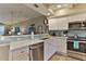 Bright kitchen showcasing white cabinetry, stainless steel appliances, and a lovely blue backsplash at 432 Bouchelle Dr # 403, New Smyrna Beach, FL 32169