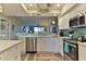 This kitchen features stainless steel appliances, quartz countertops, and a delightful blue backsplash at 432 Bouchelle Dr # 403, New Smyrna Beach, FL 32169