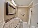 Bathroom features granite vanity and large mirror at 439 Bouchelle Dr # 202, New Smyrna Beach, FL 32169