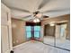 Bedroom with ceiling fan, large mirror closet and window at 439 Bouchelle Dr # 202, New Smyrna Beach, FL 32169