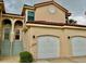 Front view of a two-story condo with a two-car garage at 439 Bouchelle Dr # 202, New Smyrna Beach, FL 32169