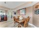 Wood dining table with four chairs in a well-lit space at 4650 Links Village Dr # D703, Ponce Inlet, FL 32127