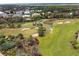 Landscaped putting green with palm trees at 4650 Links Village Dr # D703, Ponce Inlet, FL 32127