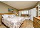 Bright bedroom featuring a king bed, window seat, and built-in shelving at 4799 S Atlantic Ave # 3030, Ponce Inlet, FL 32127