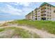 Building exterior with beach and dune views at 4799 S Atlantic Ave # 3030, Ponce Inlet, FL 32127