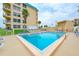 Inviting community pool and surrounding patio at 4799 S Atlantic Ave # 3030, Ponce Inlet, FL 32127