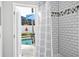 White tiled shower with access to the backyard at 508 Campana St, New Smyrna Beach, FL 32168