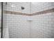 Shower with white subway tile and mosaic trim at 508 Campana St, New Smyrna Beach, FL 32168