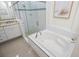 Bathroom with a soaking tub and walk-in shower at 508 Campana St, New Smyrna Beach, FL 32168