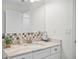 Modern bathroom vanity with granite countertop and mirror at 508 Campana St, New Smyrna Beach, FL 32168