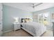 Bright bedroom with a white bed frame and window shutters at 508 Campana St, New Smyrna Beach, FL 32168