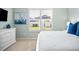 Bright bedroom with white dresser, comfy bed, and view of backyard at 508 Campana St, New Smyrna Beach, FL 32168