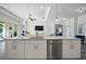 Spacious kitchen with white cabinets, granite island, and stainless steel appliances at 508 Campana St, New Smyrna Beach, FL 32168