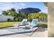 Relaxing patio with lounge chairs and umbrella near the pool at 508 Campana St, New Smyrna Beach, FL 32168