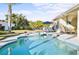 Relaxing freeform pool with spa, surrounded by a large patio at 508 Campana St, New Smyrna Beach, FL 32168