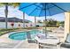 Inviting pool area with patio furniture, umbrella, and spa at 508 Campana St, New Smyrna Beach, FL 32168