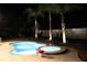 Inviting pool and spa area with night lighting at 508 Campana St, New Smyrna Beach, FL 32168