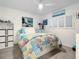 Bedroom with colorful quilt and ocean art at 5207 S Atlantic Ave # 1021, New Smyrna Beach, FL 32169