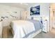 Bright bedroom with king-size bed and coastal artwork at 5207 S Atlantic Ave # 1021, New Smyrna Beach, FL 32169