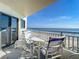 Balcony with table and chairs overlooking the ocean at 5207 S Atlantic Ave # 423, New Smyrna Beach, FL 32169