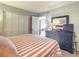 Bright bedroom with striped bedding and built-in closet at 5207 S Atlantic Ave # 423, New Smyrna Beach, FL 32169