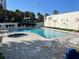 Relaxing pool and hot tub area with lounge chairs and palm trees at 5207 S Atlantic Ave # 423, New Smyrna Beach, FL 32169