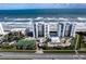 Aerial view of oceanfront condos, pool, and tennis courts at 5255 S Atlantic Ave # 1103, New Smyrna Beach, FL 32169