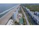 Aerial view of beachfront property with tennis courts and pool at 5255 S Atlantic Ave # 1103, New Smyrna Beach, FL 32169