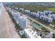 Aerial view showing oceanfront buildings and tennis courts at 5255 S Atlantic Ave # 1103, New Smyrna Beach, FL 32169