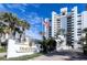 Tradewinds building, featuring a gated entrance and palm trees at 5255 S Atlantic Ave # 1103, New Smyrna Beach, FL 32169