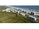 Aerial view of oceanfront community showing buildings, landscaping, and beach at 5300 S Atlantic Ave # 17-206, New Smyrna Beach, FL 32169