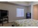 Guest bedroom with dresser and TV at 5300 S Atlantic Ave # 17-206, New Smyrna Beach, FL 32169