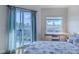 Bedroom with private balcony, desk, and comfortable bedding at 5300 S Atlantic Ave # 17-206, New Smyrna Beach, FL 32169