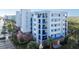 Modern condo building exterior with blue and white accents, balconies, and palm trees at 5300 S Atlantic Ave # 17-206, New Smyrna Beach, FL 32169