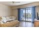 Bright living room with tiled floors and sliding glass doors to balcony at 5300 S Atlantic Ave # 17-206, New Smyrna Beach, FL 32169