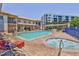 Community pool and hot tub with surrounding lounge chairs at 5300 S Atlantic Ave # 17-206, New Smyrna Beach, FL 32169