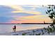 Person biking on the beach at sunset, lighthouse in the background at 5300 S Atlantic Ave # 9-507, New Smyrna Beach, FL 32169