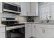 Stainless steel appliances and white cabinetry in kitchen at 5300 S Atlantic Ave # 9-507, New Smyrna Beach, FL 32169