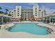 Community pool with many lounge chairs and people swimming at 5300 S Atlantic Ave # 9-507, New Smyrna Beach, FL 32169